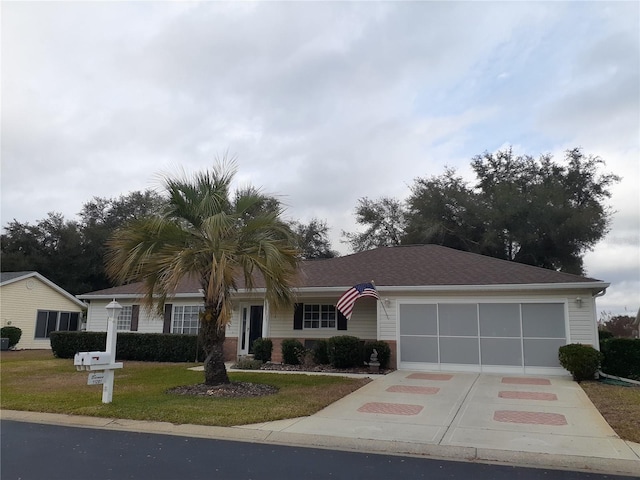 ranch-style house featuring a front yard and a garage