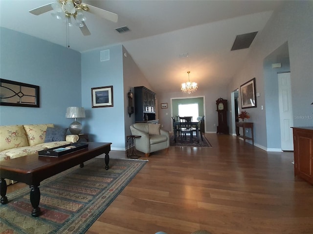 living room featuring dark hardwood / wood-style floors, ceiling fan with notable chandelier, and vaulted ceiling