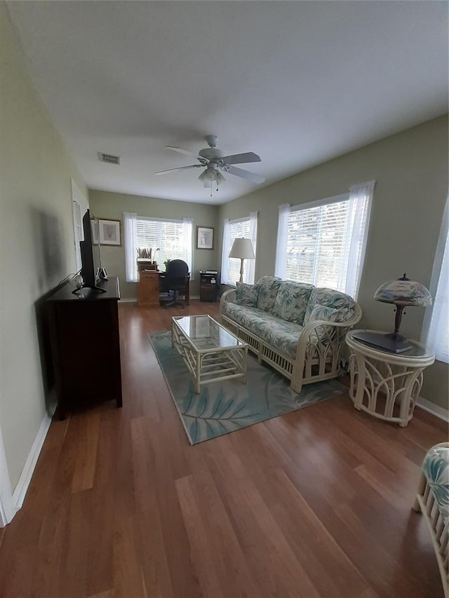 living room featuring dark hardwood / wood-style floors and ceiling fan