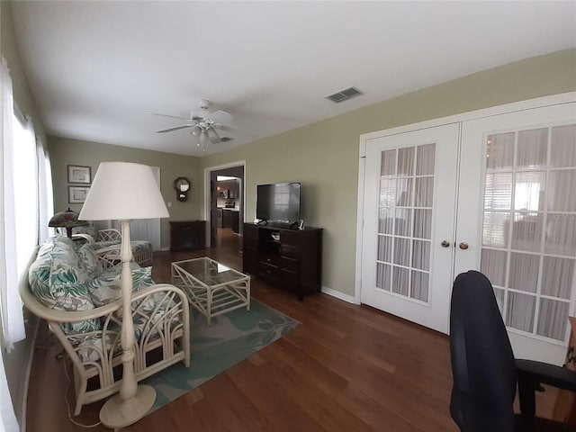 living room with ceiling fan, french doors, and dark hardwood / wood-style floors