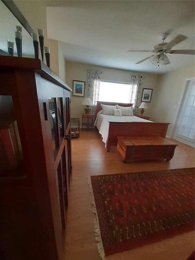 bedroom with wood-type flooring and ceiling fan