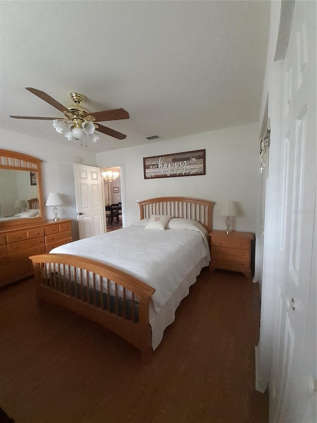 bedroom featuring ceiling fan, a closet, and dark wood-type flooring