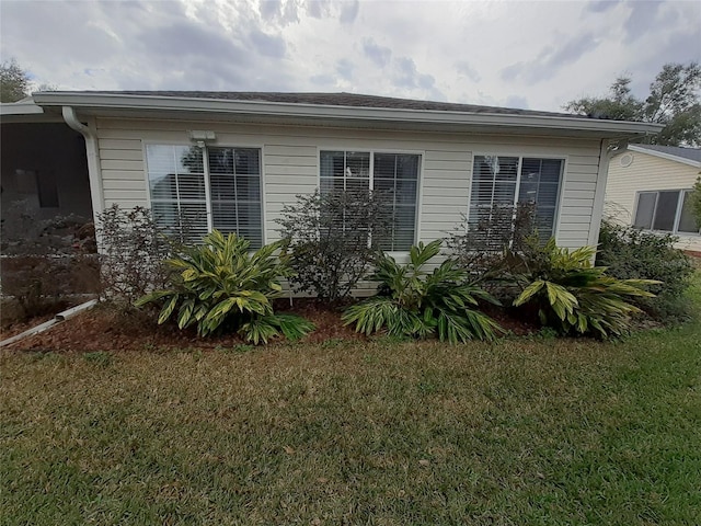 view of side of home featuring a lawn