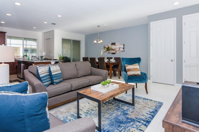 living room featuring an inviting chandelier and sink