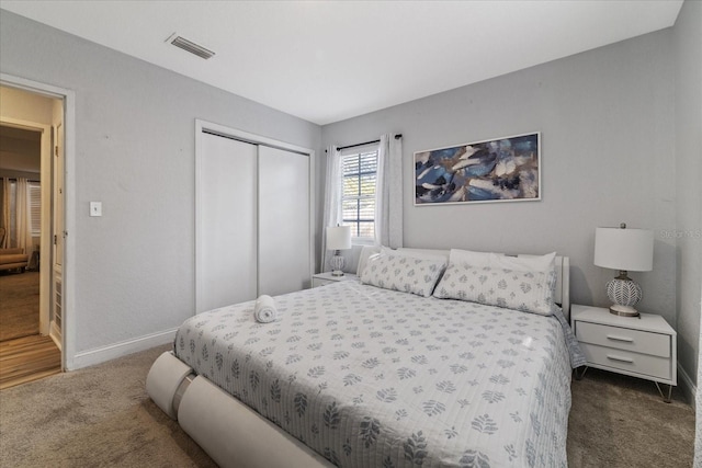 bedroom featuring dark colored carpet and a closet