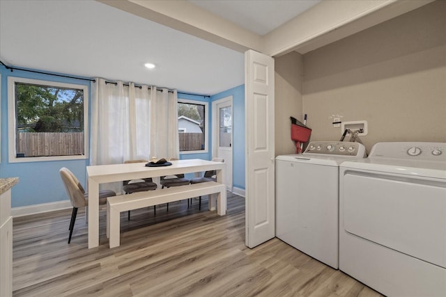 1504 E Mcberry St, Tampa, FL 33610 - laundry room with baseboards, washer and dryer, light wood-style floors, and laundry area
