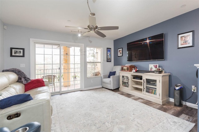 living room featuring ceiling fan and hardwood / wood-style flooring