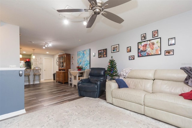 living room featuring hardwood / wood-style flooring and ceiling fan