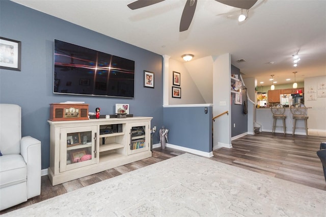 living room with hardwood / wood-style flooring and ceiling fan