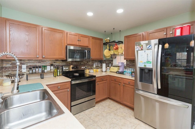 kitchen featuring sink, backsplash, and appliances with stainless steel finishes