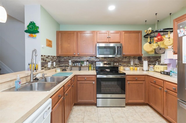 kitchen with decorative backsplash, sink, and stainless steel appliances