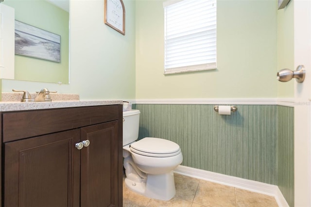 bathroom featuring tile patterned flooring, vanity, and toilet