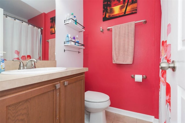 bathroom featuring tile patterned flooring, vanity, and toilet