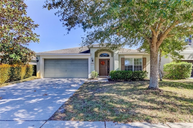 ranch-style home with a front yard and a garage