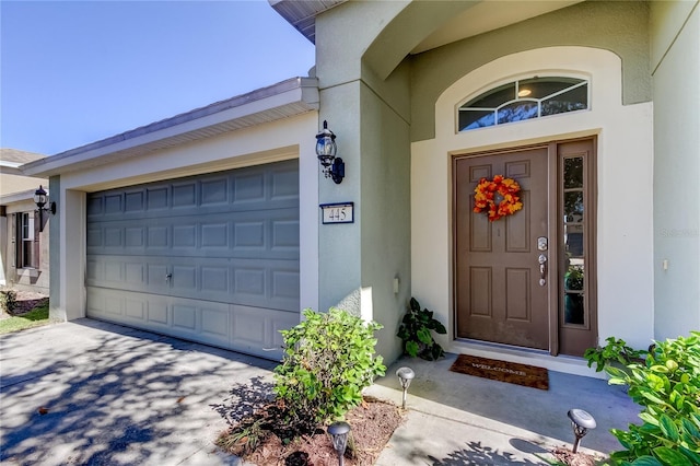 doorway to property with a garage