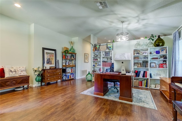 office with a chandelier, dark wood-type flooring, and vaulted ceiling