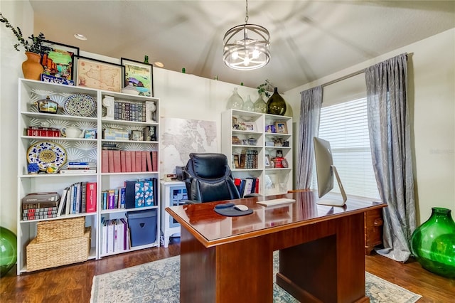 home office featuring dark hardwood / wood-style flooring and a notable chandelier