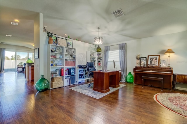 office with a healthy amount of sunlight, vaulted ceiling, and dark wood-type flooring