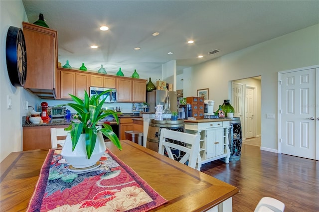 dining area with dark hardwood / wood-style flooring