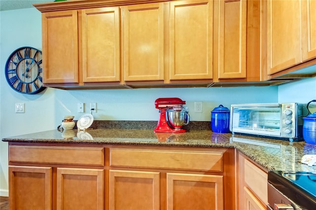 kitchen with dark stone countertops