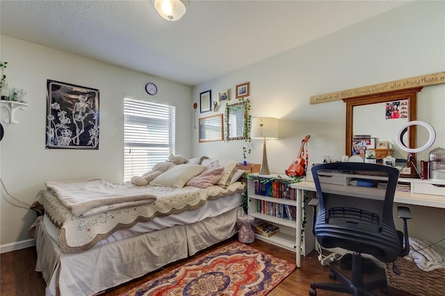 bedroom featuring dark hardwood / wood-style flooring