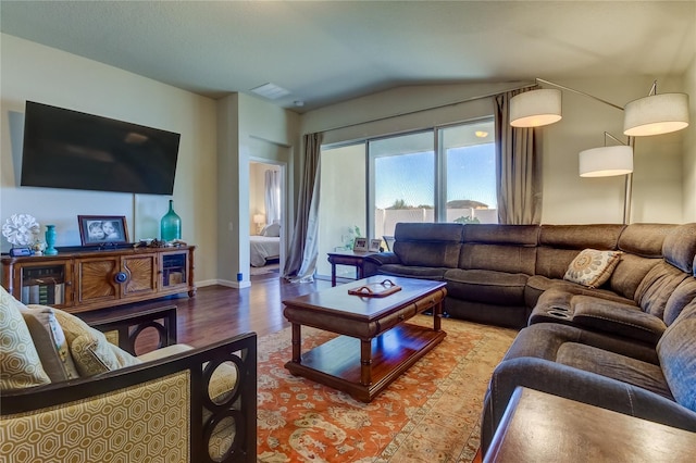 living room featuring light hardwood / wood-style floors and vaulted ceiling