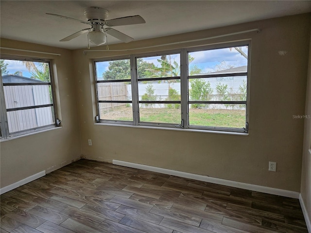 empty room with hardwood / wood-style floors and ceiling fan