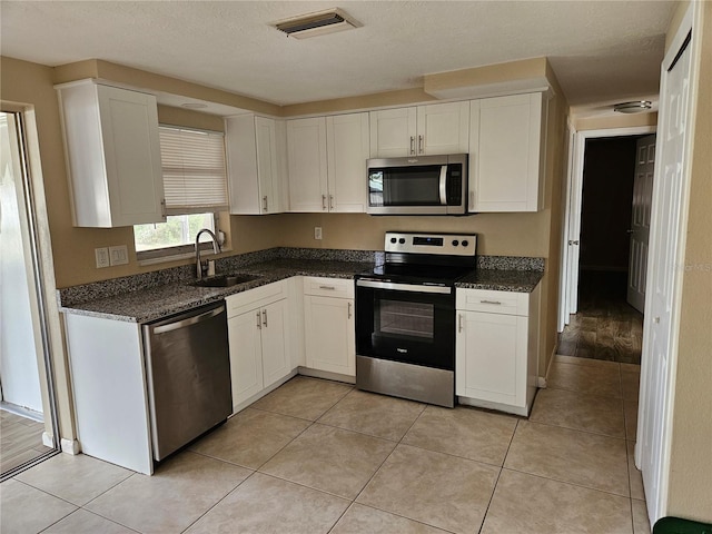 kitchen with white cabinetry, sink, and appliances with stainless steel finishes