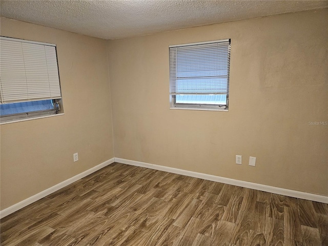 empty room featuring hardwood / wood-style floors and a textured ceiling