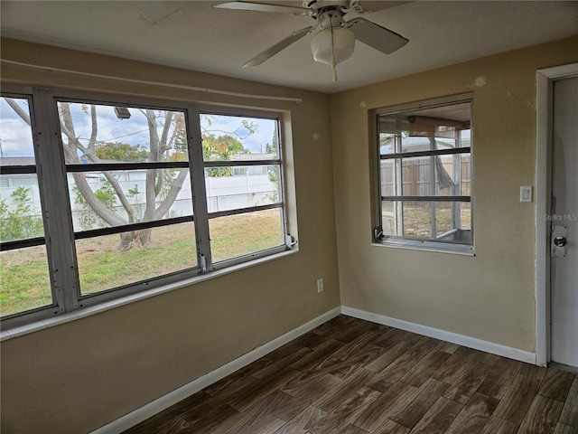 spare room with ceiling fan and dark wood-type flooring