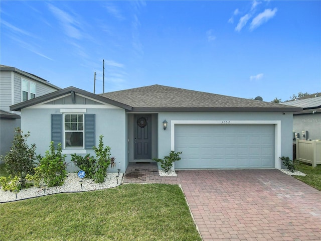 single story home featuring a garage and a front yard