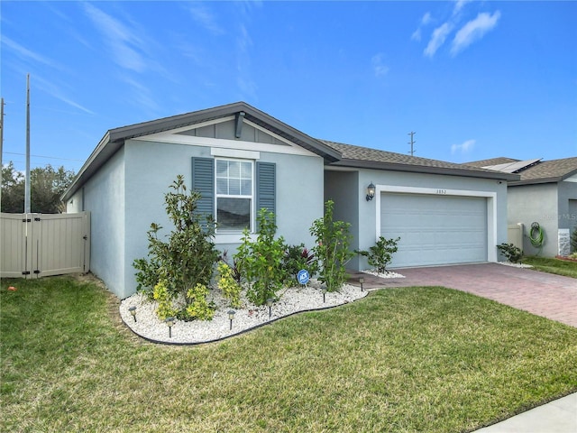 ranch-style home with a garage and a front lawn