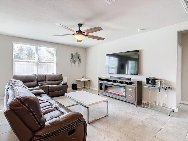 tiled living room featuring ceiling fan