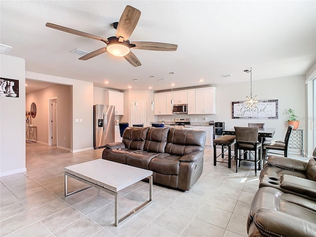 living room with ceiling fan and light tile patterned flooring