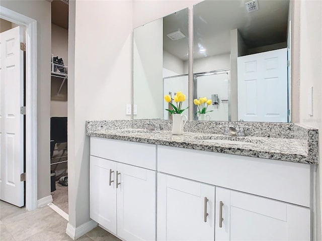 bathroom featuring vanity and a shower with shower door