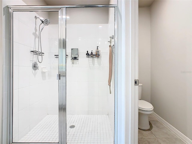 bathroom with tile patterned flooring, toilet, and walk in shower