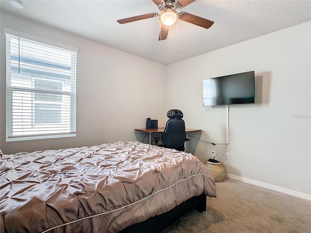 carpeted bedroom featuring multiple windows and ceiling fan