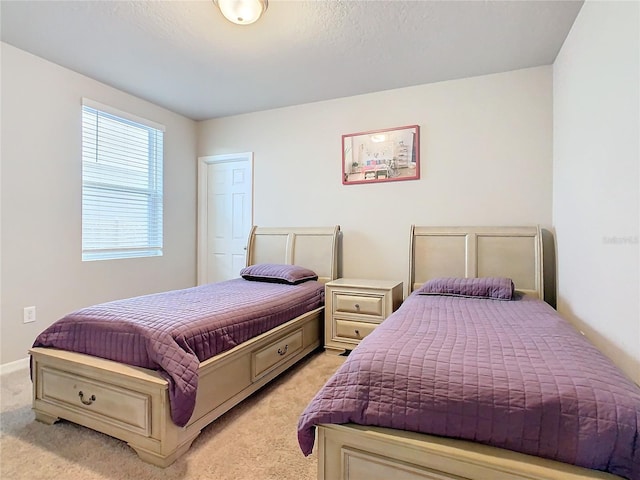 carpeted bedroom with a textured ceiling