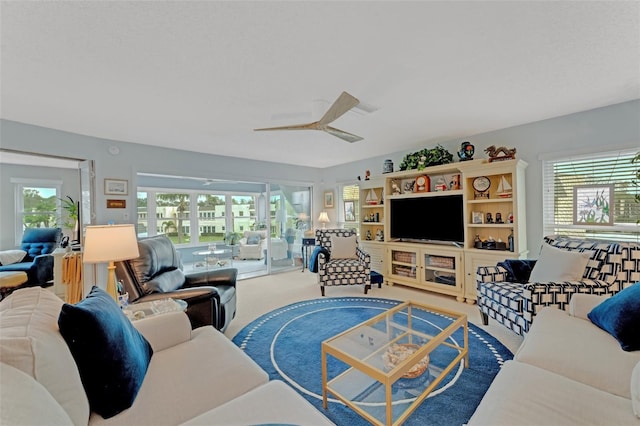 carpeted living room featuring ceiling fan