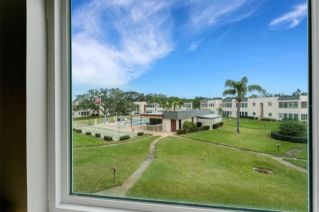 view of community with a pool and a lawn