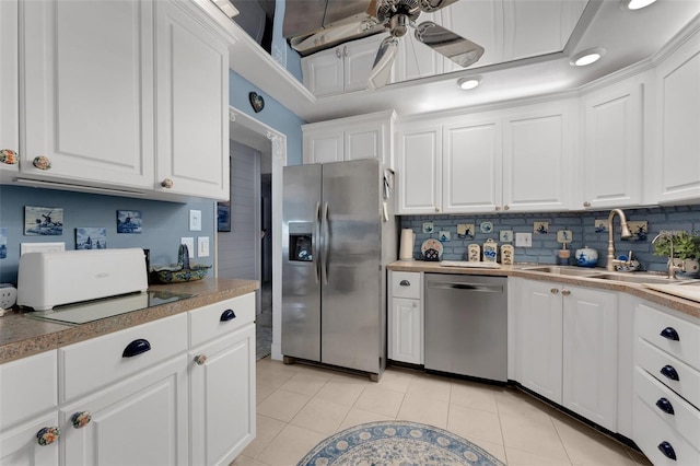 kitchen with stainless steel appliances, ceiling fan, sink, light tile patterned floors, and white cabinets