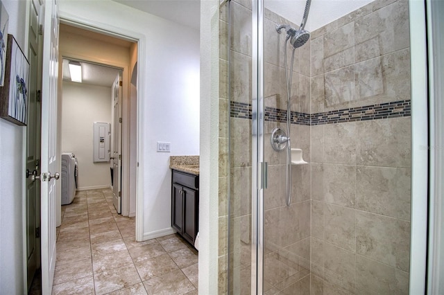 bathroom with washer / clothes dryer, vanity, and an enclosed shower