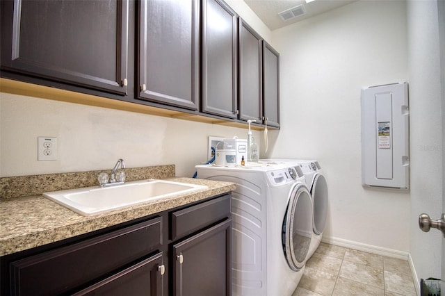 clothes washing area with sink, cabinets, independent washer and dryer, electric panel, and light tile patterned floors