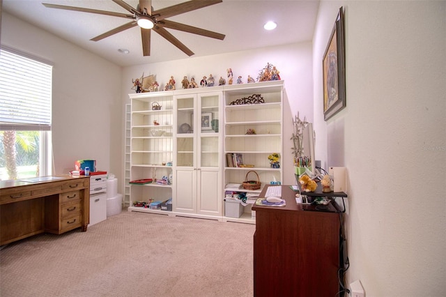 home office with light carpet and ceiling fan