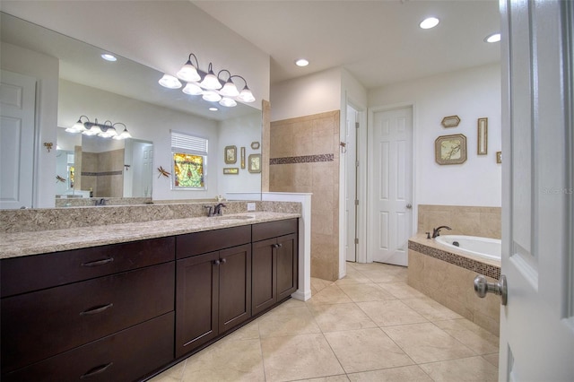 bathroom with tile patterned floors, vanity, and shower with separate bathtub