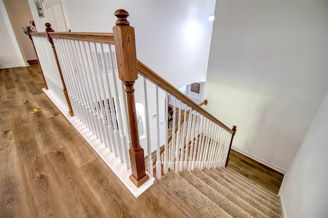 stairs with hardwood / wood-style floors