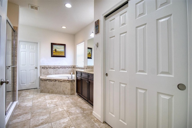 bathroom with tile patterned floors, vanity, and plus walk in shower