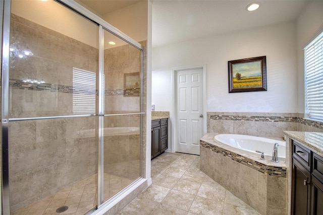 bathroom with tile patterned floors, vanity, and separate shower and tub