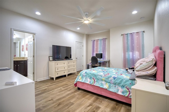 bedroom with ceiling fan, light wood-type flooring, and connected bathroom