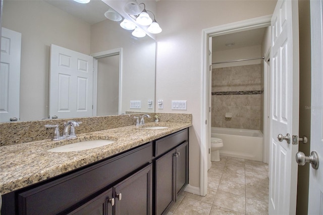 full bathroom featuring tile patterned flooring, vanity, toilet, and tiled shower / bath